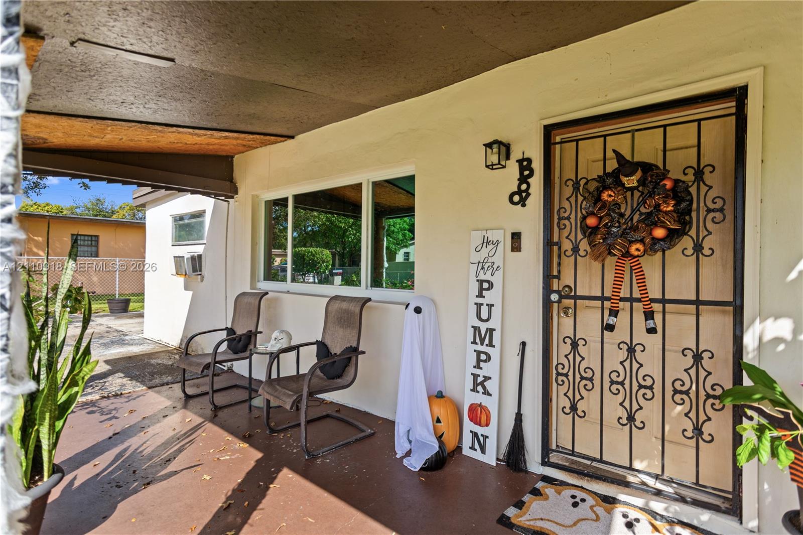 Covered front porch featuring a decorative wrought