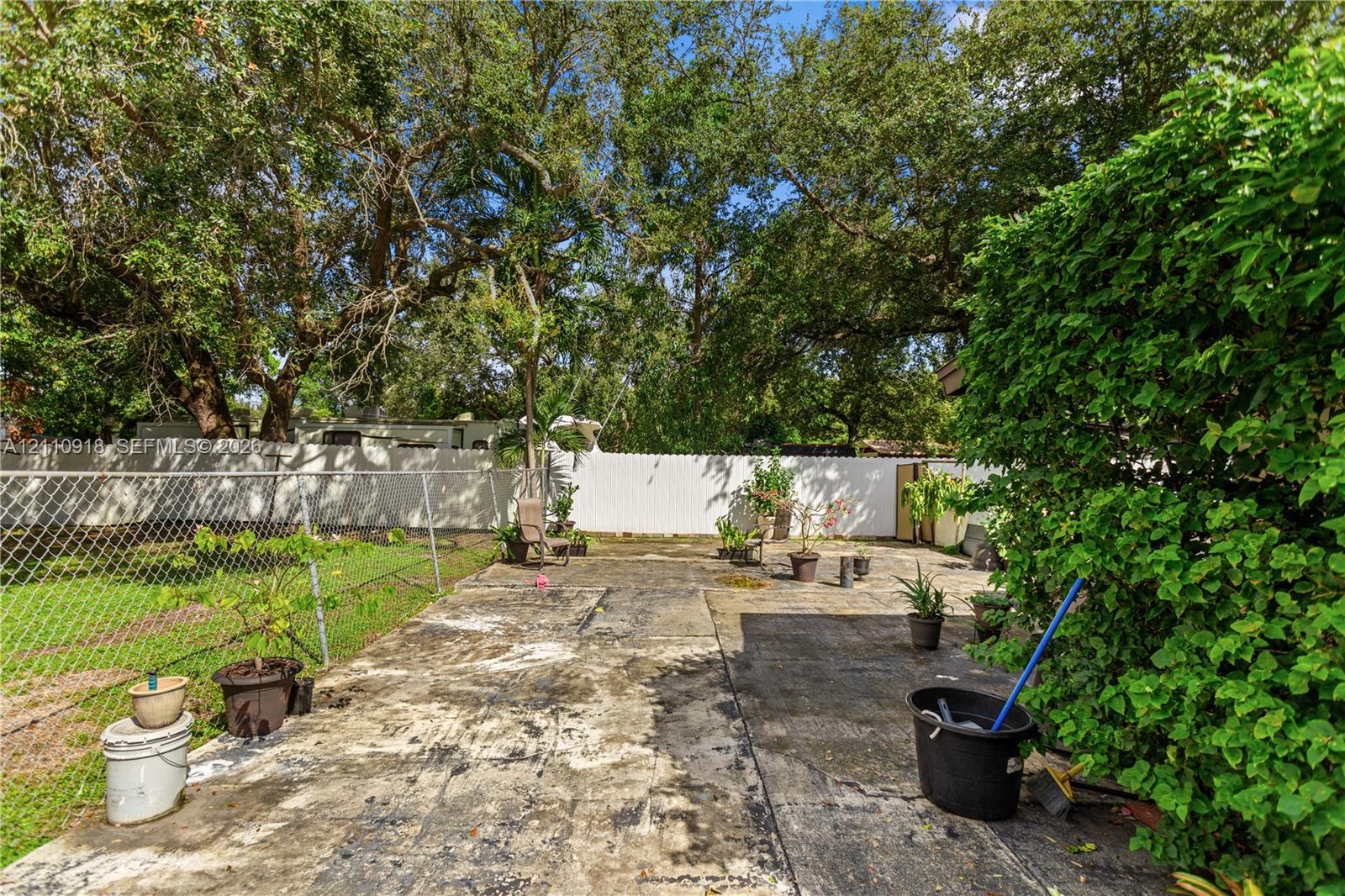 Backyard featuring a concrete patio, perimeter cha