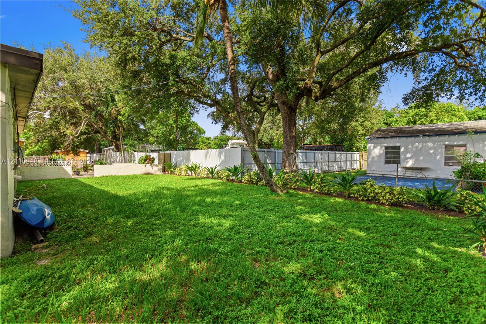 Expansive backyard featuring a manicured lawn, mat