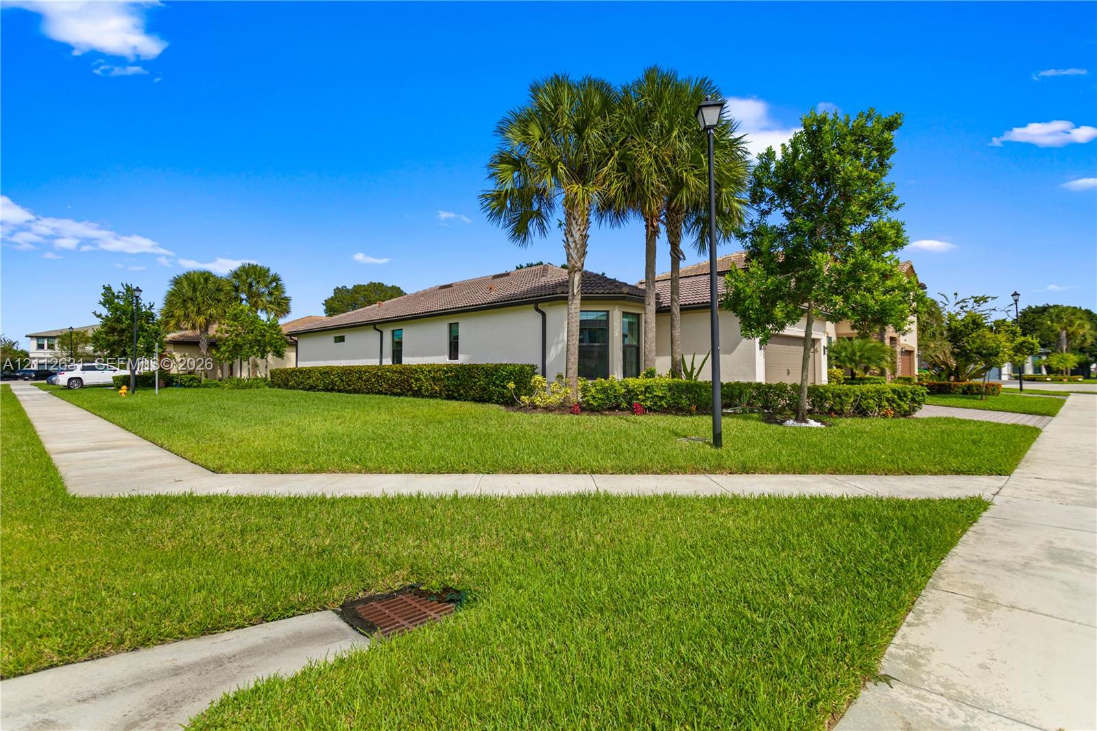 Corner lot featuring a stucco exterior, a tiled ro