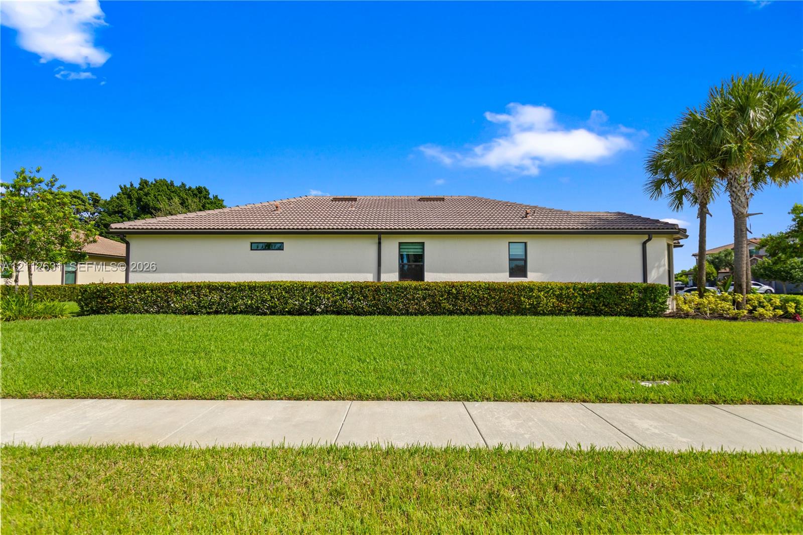 Exterior elevation featuring a tile roof, stucco s