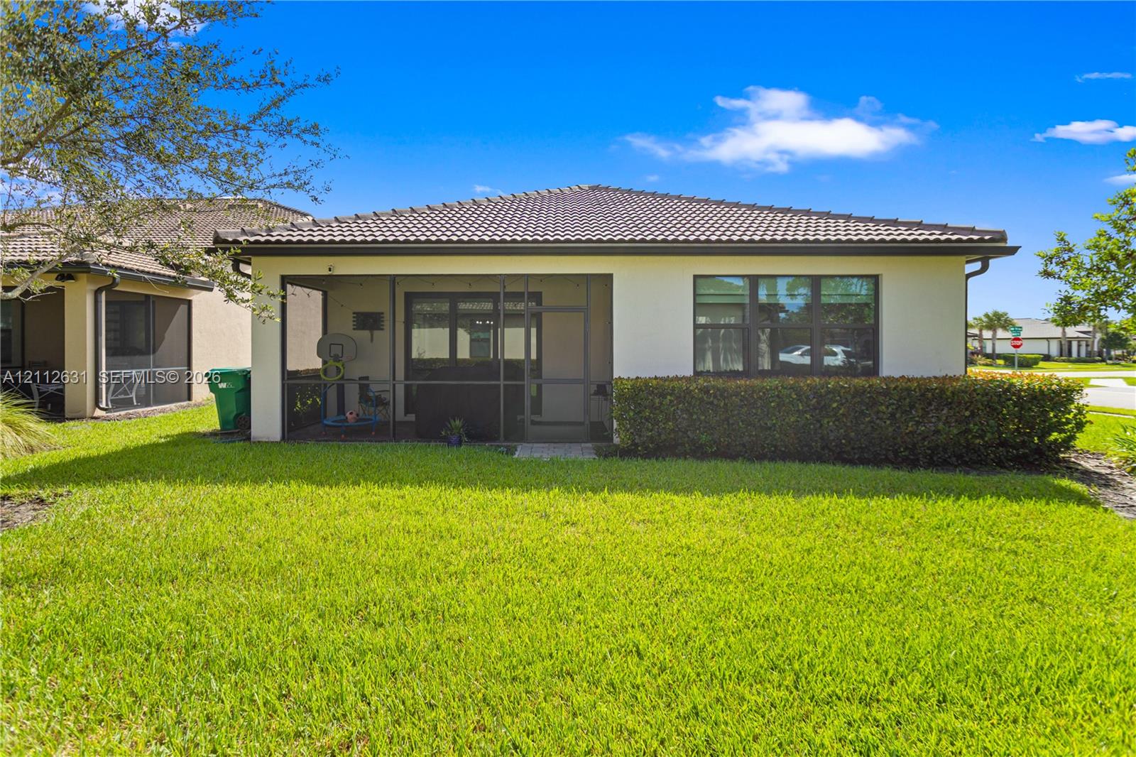 Exterior rear elevation featuring a screened-in la