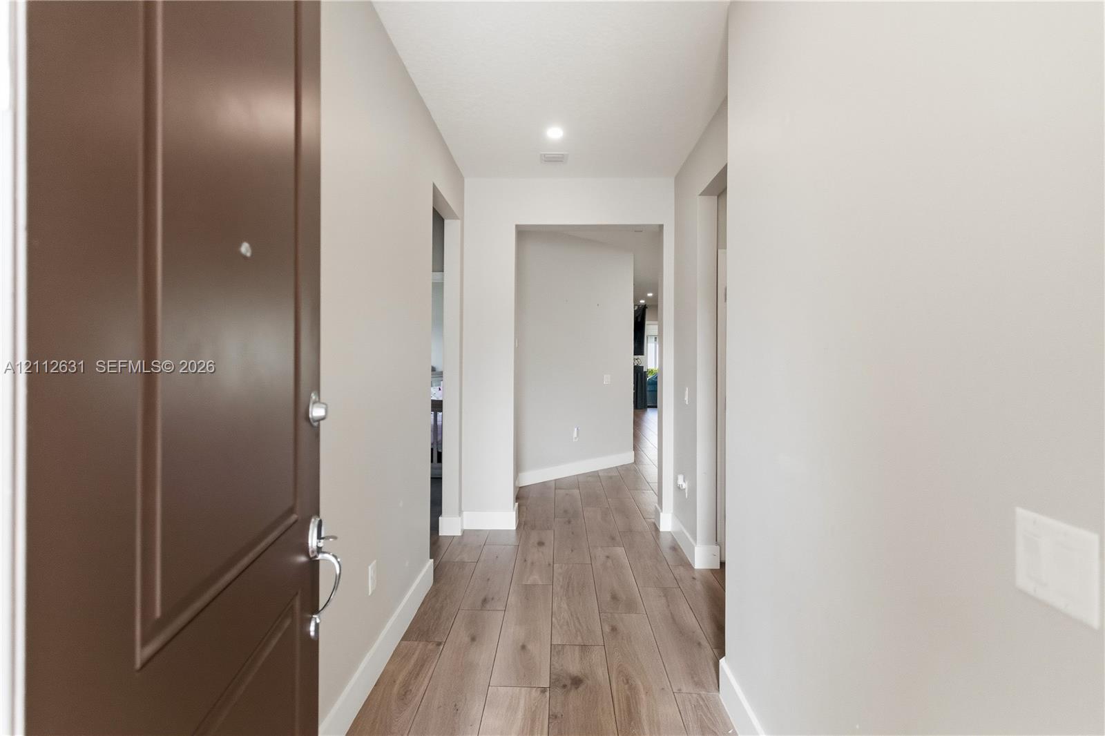 Entry foyer featuring wood-finish flooring, a soli