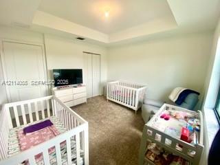 Tray ceiling featuring a central light fixture, wa