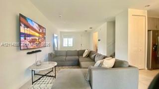 Open-concept interior featuring light-toned floori
