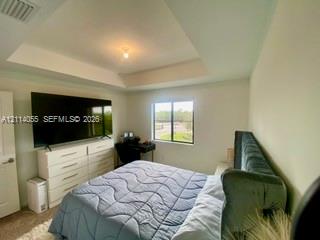 Tray ceiling featuring a center-mounted light fixt